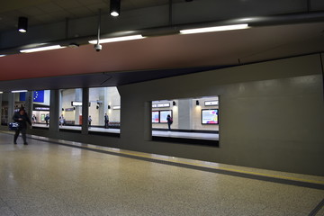 Brussels Schuman train station with some people waiting for train on both platforms