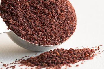 Ground Sumac Spilled from a Teaspoon