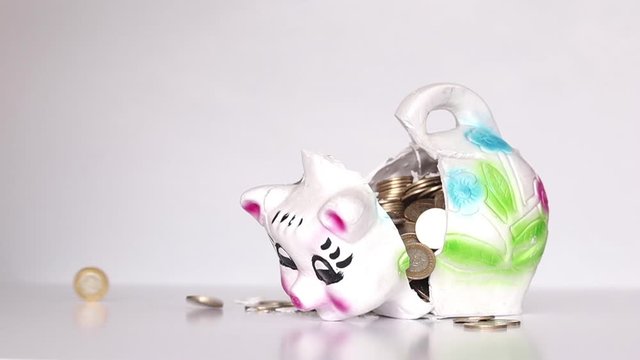 Breaking piggy bank with a hammer