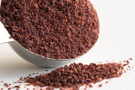 Ground Sumac Spilled from a Teaspoon