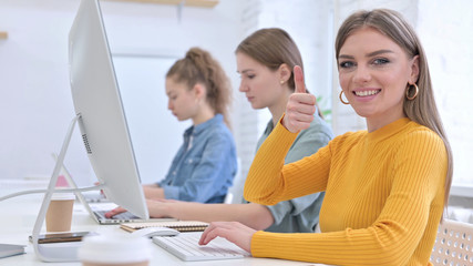 Fototapeta premium Ambitious Creative Woman showing Thumbs Up