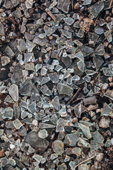 Broken glass on floor background, top view, abstract