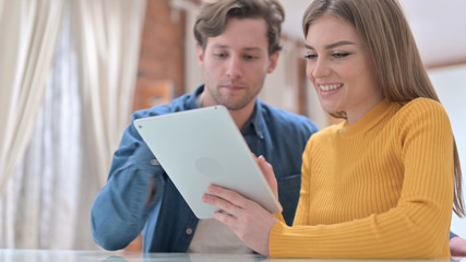 Young Couple using Tablet at Home