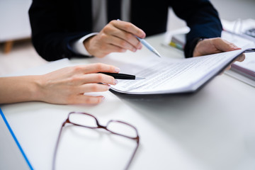 Two Businesspeople Analyzing Document