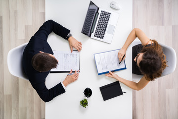 Businesswoman Interviewing Male Candidate In Office