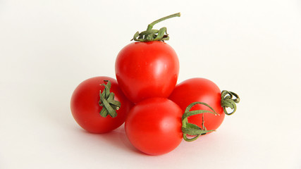 tomatoes in a bowl isolated on white background