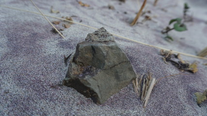 rock in the purple sand