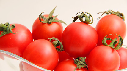  fresh tomatoes in a bowl isolated on white