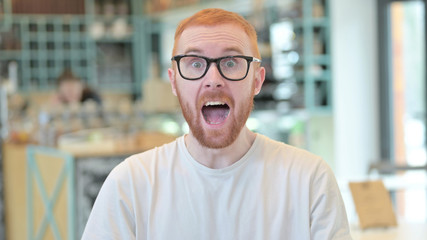 Obraz premium Portrait of Excited Redhead Man Celebrating Success