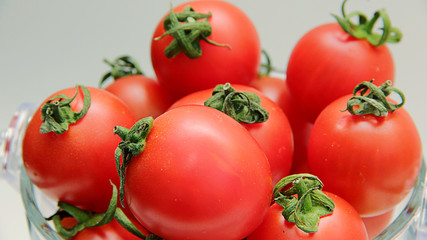  fresh tomatoes in a bowl isolated on white