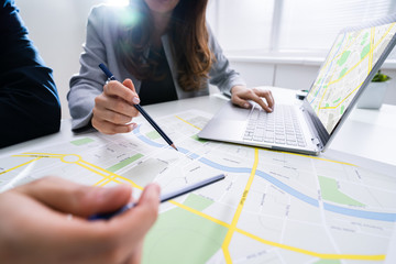 Two People Looking At City Map