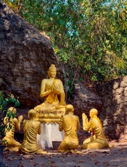 Golden statues of Buddha and disciples at Mount Phou Si, in Luang Prabang, Laos.