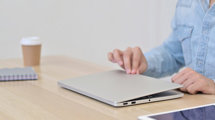Fototapeta premium Hands of Male Designer Opening on Laptop