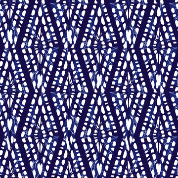 Vector blue shibori monochrome vertical diamonds zig zag seamless pattern. Suitable for textile, gift wrap and wallpaper.