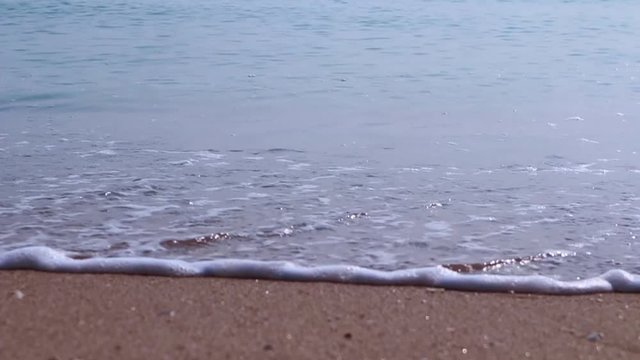 Slow motion close up ocean wave and beach