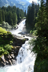 Fototapeta na wymiar The Krimml Waterfalls (German: Krimmler Wasserfälle) are the highest waterfall in Austria. Water in Europe with spray in summer