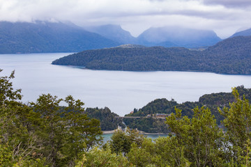 Obraz premium Correntoso river bridge with Lake Correntoso and Nahuel Huapi lake in background. Pataognia Argentina