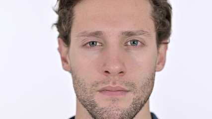 Obraz premium Close up of Serious Young Man Face on White Background