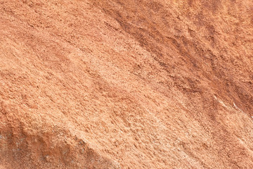 Red mountainside on hot day. Texture on wall of sandy canyon. Lack of water, drought from climate change