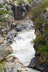 rapid river in mountain gorge, bubbling stream among the rocks,  test for rafting