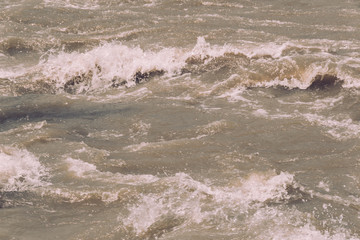 Obraz premium rushing water of fast flowing river, storm waves of ocean, sea surf