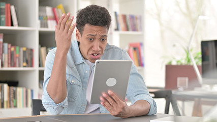 Young African American Man Disappointed by Loss on Tablet, Failure