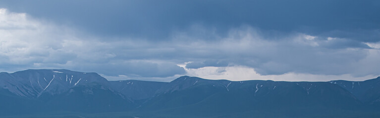 stormy sky over rocky ridge, waiting for rain and storm in mountain valley