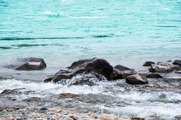 Naklejka premium stone seashore river, stormy sea surf, rapid mountain stream