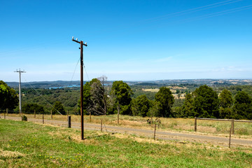 Fototapeta premium A rural road with beautiful grassland and beautiful sky