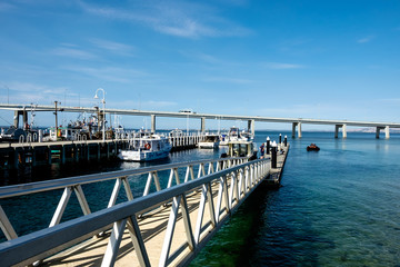 Obraz premium Fishing yachts parked at dock with a bridge connecting Phillip Island with San Remo area