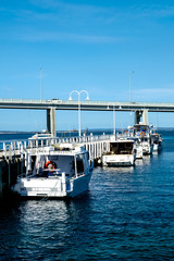 Fishing yachts parked at dock with a bridge connecting Phillip Island with San Remo area