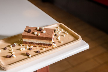 chocolate cake on wooden plate in mini cafe