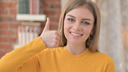 Portrait of Successful Young Woman doing Thumbs Up