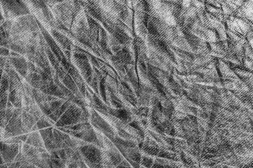 Grey uneven shiny texture background. Metallic crumpled gray background.