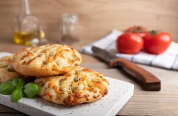 Freshly baked Italian bread Focaccia on a white stone plate.