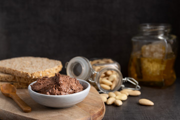 Homemade organic vegan chocolate spread, made of almonds, honey and cacao. With a jar of rice milk