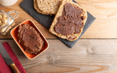 Homemade organic vegan chocolate spread, made of almonds and organic cacao and honey. Top view.