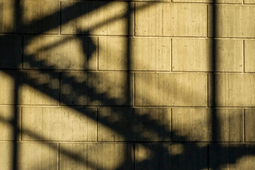 Stockholm, Sweden The shadow of a man walking on stairs underneath the Liljeholmen bridge.
