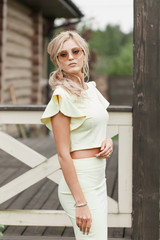 Stylish bridesmaid in yellow dress posing