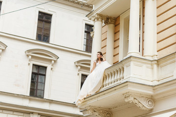 Fototapeta na wymiar morning of the bride. bride on the balcony in the morning