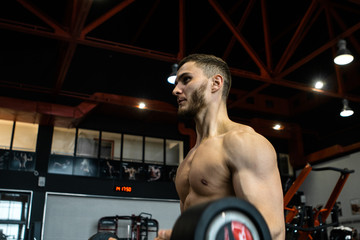 handsome bearded guy training in a gym