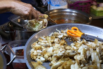cooking pilaf in a cauldron on fire