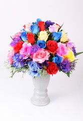 Colorful flower arrangement centerpiece in white ceramic vase