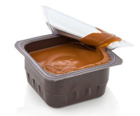 Chocolate cream in plastic container.  Curdy dessert with chocolate flavor. In Slovak called:...