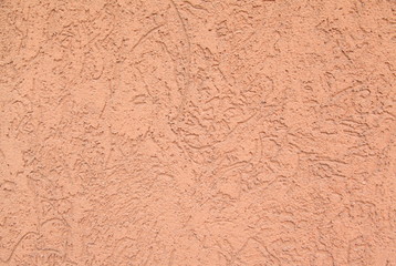 Fototapeta premium Orange striated stucco wall texture