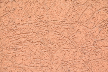 Orange striated stucco wall texture
