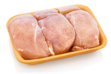 Chicken breast from the shop, unpacked, without foil. Raw sliced chicken meat on polystyrene tray. Isolated on white background with shadow reflection. With clipping (vector) path.
