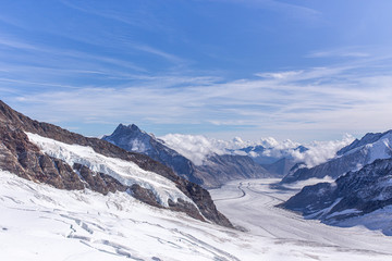 Fototapeta na wymiar Great Aletsch glacier and Bernese Alps and jungfrau snow mountain peak with blue sky background view from Jungfraujoch top of Europe, Switzerland