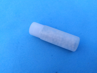 white plastic medicine bottle isolated on blue sky background