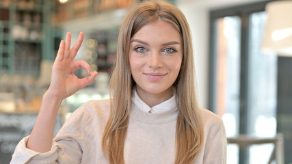 Portrait of Ok Sign by Cheerful Young Woman